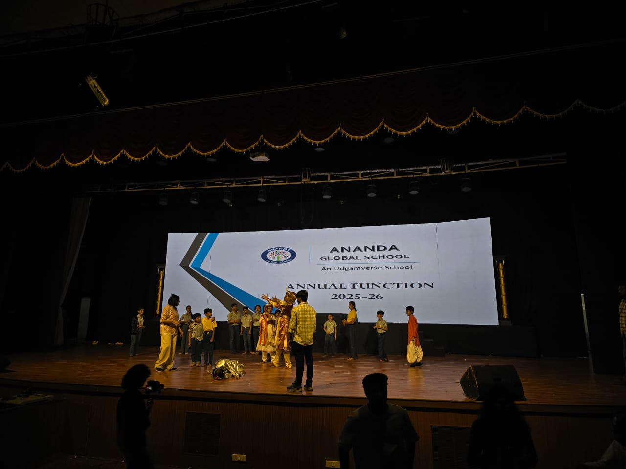 Students performing Birbal v/s AI on stage at Ananda Global School